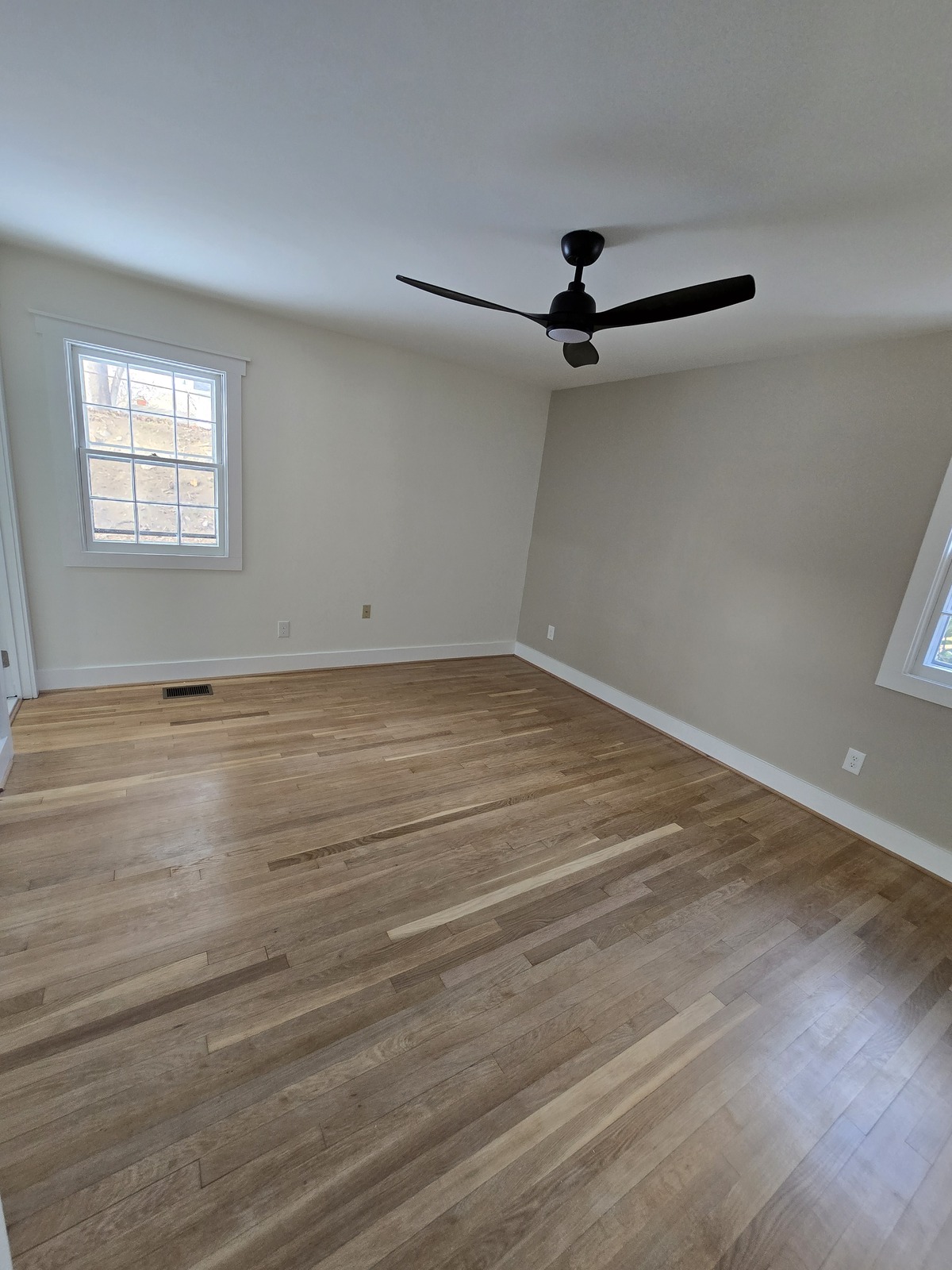 Natural wood flooring in a neutral-painted room